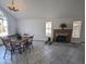 Bright dining room with a view from a large window and a fireplace in the adjacent living area at 4636 E Carmen St, Phoenix, AZ 85044