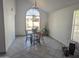 Bright dining room with a large window providing natural light and a wooden table with chairs at 4636 E Carmen St, Phoenix, AZ 85044
