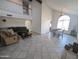 Spacious living room featuring high ceilings, tile flooring, and a large arched window for natural light at 4636 E Carmen St, Phoenix, AZ 85044
