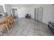 Open floor plan showcasing tile floors, a breakfast bar with wooden stools, and neutral wall colors at 4636 E Carmen St, Phoenix, AZ 85044