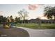 Sunset view of a playground, green space, and mountain range in background at 4636 E Carmen St, Phoenix, AZ 85044