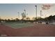 Well-lit tennis court with mountain view during twilight at 4636 E Carmen St, Phoenix, AZ 85044