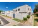 Inviting townhome showcasing white stucco exterior, private yard, and well-maintained landscaping at 5201 N 42Nd N Pkwy, Phoenix, AZ 85019