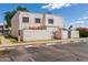 Exterior showcasing complex with stucco facade, assigned parking, and mature trees, providing a vibrant community at 5201 N 42Nd N Pkwy, Phoenix, AZ 85019