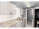 Functional kitchen featuring white cabinets, stainless steel appliances, and stone countertops at 5201 N 42Nd N Pkwy, Phoenix, AZ 85019