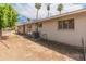 Exterior view showcasing a backyard with a patio, gravel and grass and mature trees at 524 W Fairway Dr # 9, Mesa, AZ 85201