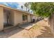 Private backyard featuring a covered patio and a mix of grass and gravel landscape at 524 W Fairway Dr # 9, Mesa, AZ 85201