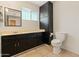 Functional bathroom with dark cabinets, ample countertop space, and essential fixtures at 524 W Fairway Dr # 9, Mesa, AZ 85201