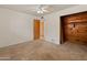 Comfortable bedroom featuring carpet, an open closet, and an open doorway, ready for customization at 524 W Fairway Dr # 9, Mesa, AZ 85201