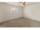 Bright bedroom with neutral carpet, ceiling fan, and window providing natural light at 524 W Fairway Dr # 9, Mesa, AZ 85201