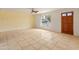 Bright living room featuring tile floors, a ceiling fan and a large front window at 524 W Fairway Dr # 9, Mesa, AZ 85201