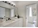 Modern bathroom with marble countertops, a large mirror, and updated fixtures at 5430 E Shea Blvd, Scottsdale, AZ 85254