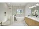 Luxurious bathroom featuring a standalone tub, a walk-in shower, and elegant fixtures at 5430 E Shea Blvd, Scottsdale, AZ 85254