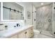 Modern bathroom with a marble walk-in shower, lighted mirror, and wood vanity at 5430 E Shea Blvd, Scottsdale, AZ 85254