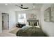 Bright bedroom with light wood floors, artwork, and a large window at 5430 E Shea Blvd, Scottsdale, AZ 85254