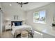 Cozy bedroom featuring a ceiling fan, plush bedding, and natural light through the window at 5430 E Shea Blvd, Scottsdale, AZ 85254