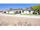 Beautiful exterior showcasing a spacious driveway, lush green lawn, and well-designed landscaping at 5430 E Shea Blvd, Scottsdale, AZ 85254