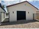 Exterior view of a two car garage with a black garage door, with black iron gates on either side at 5430 E Shea Blvd, Scottsdale, AZ 85254