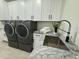Functional laundry room with granite countertops, modern appliances, and ample cabinet space at 5430 E Shea Blvd, Scottsdale, AZ 85254