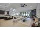 Open-concept living space with adjacent kitchen, fireplace, large sectional couch and pool views at 5430 E Shea Blvd, Scottsdale, AZ 85254