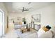 Bright living room featuring neutral tones, contemporary decor, and a ceiling fan for added comfort at 5430 E Shea Blvd, Scottsdale, AZ 85254
