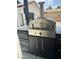 Outdoor kitchen features a pizza oven and stainless steel accents for culinary adventures at 5430 E Shea Blvd, Scottsdale, AZ 85254