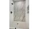 Modern walk-in shower features marble tile and matte black fixtures at 5430 E Shea Blvd, Scottsdale, AZ 85254