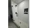 Modern walk-in shower with subway tile, glass door, and black hardware details at 5430 E Shea Blvd, Scottsdale, AZ 85254