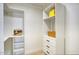 Clean walk-in closet featuring custom white shelving and drawers at 5430 E Shea Blvd, Scottsdale, AZ 85254