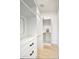Bright walk-in closet featuring custom white built-ins, drawers, shelving, and hanging rods at 5430 E Shea Blvd, Scottsdale, AZ 85254