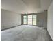 An unfinished room featuring smooth drywall, a sliding glass door to the backyard and concrete floors at 5507 W Piedmont Rd, Laveen, AZ 85339