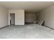 Unfinished room features smooth drywall, a closet, and a pass through to another room at 5507 W Piedmont Rd, Laveen, AZ 85339