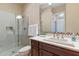 Bathroom featuring tiled walk-in shower, wood cabinet vanity, and modern fixtures at 5512 E Barwick Dr, Cave Creek, AZ 85331