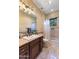 Bathroom featuring a dark wood vanity, shower and tub combo, and neutral tile at 5512 E Barwick Dr, Cave Creek, AZ 85331