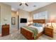 Comfortable bedroom with a wood bed frame, ceiling fan, and mounted television at 5512 E Barwick Dr, Cave Creek, AZ 85331