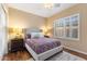 Cozy bedroom with a padded headboard, side tables with lamps, and plantation shutters at 5512 E Barwick Dr, Cave Creek, AZ 85331