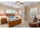 Comfortable bedroom with a wood bed frame, ceiling fan, and matching end tables at 5512 E Barwick Dr, Cave Creek, AZ 85331
