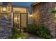 Elegant stone entryway with an ornate metal gate and manicured landscaping with lighting at 5512 E Barwick Dr, Cave Creek, AZ 85331