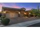 Charming home showcasing desert landscaping, a stone facade, and a three car garage at 5512 E Barwick Dr, Cave Creek, AZ 85331