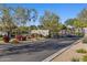 Gated entrance to the community, surrounded by lush landscaping and mature trees at 5512 E Barwick Dr, Cave Creek, AZ 85331