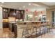Stylish kitchen with a breakfast bar, custom cabinetry, and views into the dining area at 5512 E Barwick Dr, Cave Creek, AZ 85331