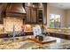 Close up shot of the kitchen's island and dark wood cabinets at 5512 E Barwick Dr, Cave Creek, AZ 85331