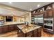 Open kitchen layout featuring a large island, stainless steel appliances and dark wood cabinets at 5512 E Barwick Dr, Cave Creek, AZ 85331