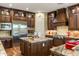 Gourmet kitchen featuring custom wood cabinetry, an island, and stainless steel appliances at 5512 E Barwick Dr, Cave Creek, AZ 85331