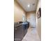 Spacious laundry room with front loading washer and dryer on top of travertine tile flooring at 5512 E Barwick Dr, Cave Creek, AZ 85331