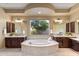 The main bathroom features a large soaking tub, dual sinks and vanities, and natural light at 5512 E Barwick Dr, Cave Creek, AZ 85331