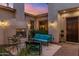 Enclosed outdoor patio with fireplace, travertine flooring, and cozy seating for entertaining at 5512 E Barwick Dr, Cave Creek, AZ 85331