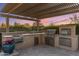 Outdoor kitchen area with stainless steel appliances under a pergola at 5512 E Barwick Dr, Cave Creek, AZ 85331