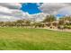 Well-maintained community park with lush green grass, walking paths, and mature trees at 5512 E Barwick Dr, Cave Creek, AZ 85331