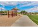 Community playground with play structure, set along a paved path within a green space at 5512 E Barwick Dr, Cave Creek, AZ 85331